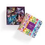 Colorful floral-patterned Liberty origami paper in a box on a white background