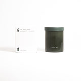 A green glass jar labeled 'FIELD KIT' containing a candle.