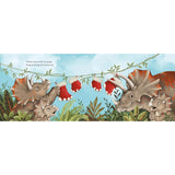 A horizontal illustrated book page featuring cartoon dinosaurs hanging red Christmas stockings in a prehistoric jungle scene under a light blue sky.