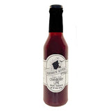 Bottle of red sauce with label the reads ' Lighthouse Keepers Cape Cod Cranberry Lime Hot Sauce'