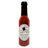 A jar of Cherry Pepper Shark Bait Hot Sauce with a label that includes the brand name and product description.