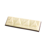 An unwrapped chocolate candy bar with four molded sailboats on top