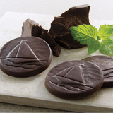 Marblehead Mint chocolates with a design that includes a sailboat.