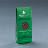 A green Gable box of Harbor Sweets Marblehead Mint chocolates with a design that includes a sailboat.