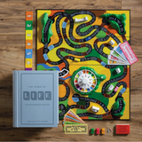 The Game of Life Vintage Bookshelf Edition board game set on display, including the game board, cards, spinner, mountains, bridge, buildings, car pawns, people pegs, money, insurance policies, stock certificates, and promissory notes.