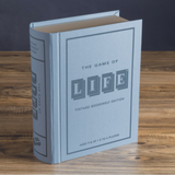 A vintage-style bookshelf edition of 'The Game of Life' with a blue linen cover, displaying the game's title on the front.