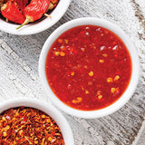 Bowls of hot sauce and chili peppers