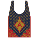 A tote bag with a geometric pattern featuring a prominent gold 'A' on a navy background, reflecting the cover design of Nathaniel Hawthorne's novel The Scarlet Letter.