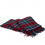 Folded tartan blankets with red, blue, green, and yellow stripes, with fringes on the edges.