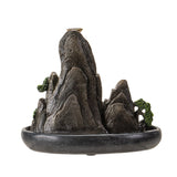 Decorative mountain-shaped incense burner on a white background