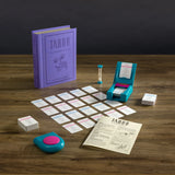 Taboo game components including cards, container, and rulebook on a wooden surface.
