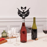Bottle opener shaped like a bat on a wine bottle with glasses and another bottle in the background.