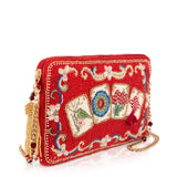 A red beaded clutch purse featuring four beaded mahjong tile designs on the front, gold-tone chain straps, and a gold tassel, shown on a white background.