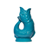 Turquoise ceramic fish-shaped vase pitcher on a white background