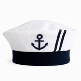 Navy blue and white sailor hat with an anchor emblem on a white background