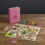 Candy Land board game set with pink instruction book on a wooden surface