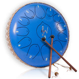 Blue steel tongue drum with two drumsticks on a white background