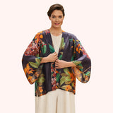 Woman wearing a colorful floral kimono-style jacket on a white background