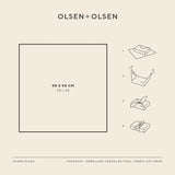 Instructional diagram for Olsen+Olsen fabric gift wrap showing a 90 x 90 cm square with four step-by-step folding illustrations on a light beige background.