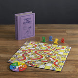 Chutes and Ladders board game with pieces and spinner on a wooden surface