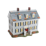 Model of a two-story house with decorative elements on a white background
