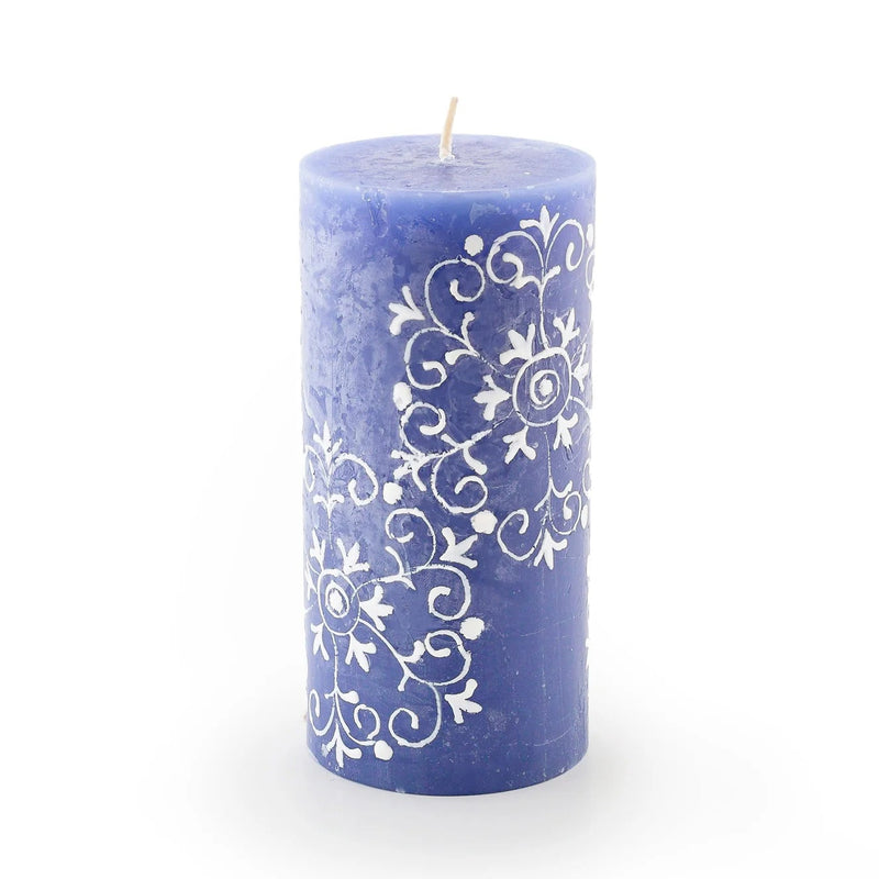 Blue candle with white decorative pattern on a white background