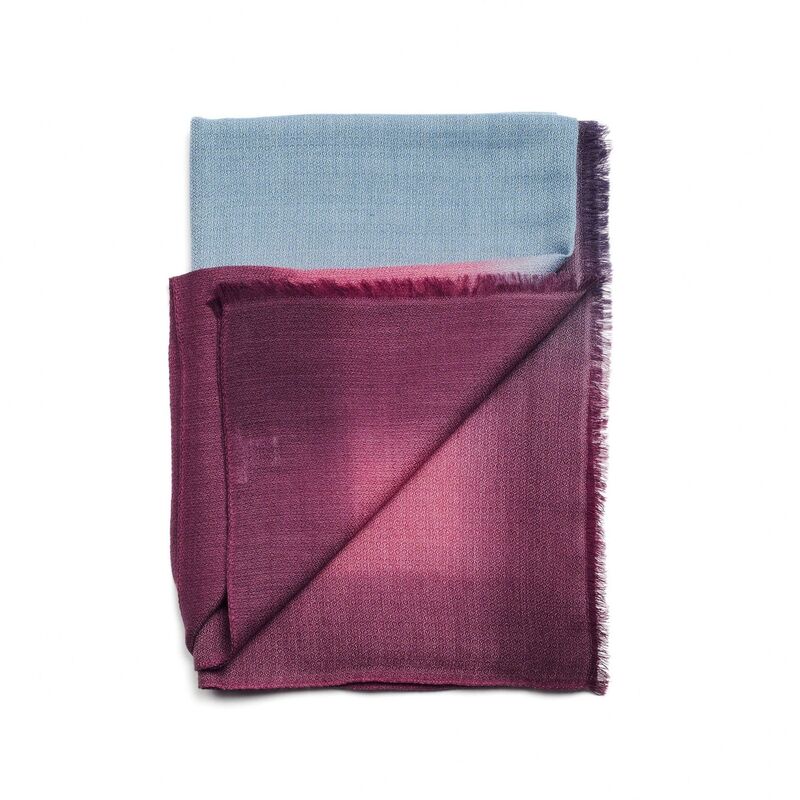 Folded fabric with blue and purple gradient on a white background