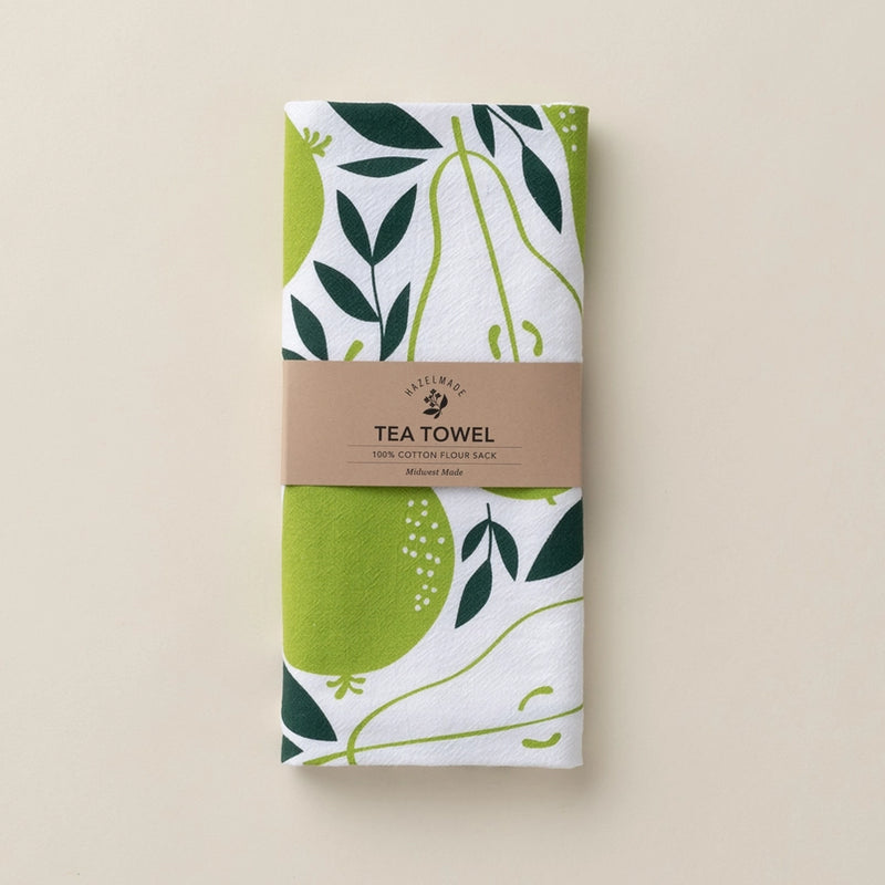 Tea towel with green and leaf pattern on a beige background
