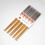 Set of bamboo chopsticks with a branded box on a white background