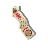 Hair clip in shape of four overlapping mahjong tiles on a white background