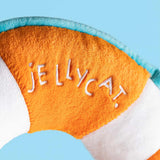 Close-up of a plush toy with 'JELLYCAT' branding on an orange and white background.