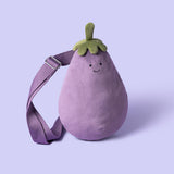 Plush toy bag shaped like an eggplant with a smiling face on a purple background