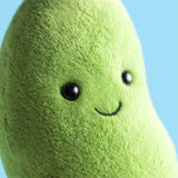 Plush edamame toy with a smiling face against a blue background
