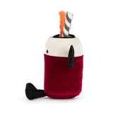 A plush toy shaped like a vampire drink in a glass, with a deep red body, white rim, black wings, black feet, a striped straw, and an orange slice decoration on a white background.