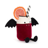 A plush toy shaped like a vampire drink in a glass, with a deep red body, white rim, black wings, black feet, a striped straw, and an orange slice decoration on a white background.
