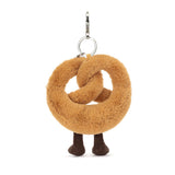 Plush pretzel keychain with legs on a white background