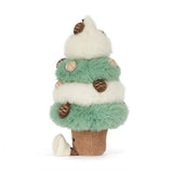 White and green plush tree covered in pinecones. Has a corded tan trunk with a smiling face embroidered on it.