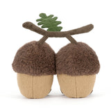 Stuffed acorn toy with a branch on a white background