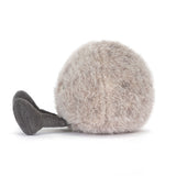 Plush toy resembling a round small stone with a smiling face on a white background