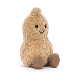 A soft plush toy resembling a peanut with a beige body, brown boots, and a smiling face.
