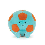 Plush toy soccer ball with a smiling face on a white background