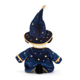 A plush dog toy dressed as a wizard, featuring a navy blue velvet robe and pointed hat with gold star patterns and trim, set against a plain white background.