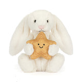 White plush bunny holding a gold star  with a smiley face on a white background