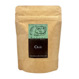 Kraft paper packaging with a label for Kakawa Chocolate House Chili on a white background