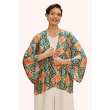 Woman wearing a colorful patterned kimono-style garment on a white background