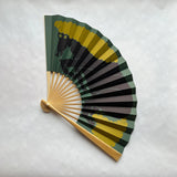 Handheld fan with horse design on a white background