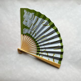 Handheld fan with tiger design on a light gray background