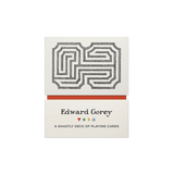 The product shown is the box/package for the Edward Gorey 'A Ghastly Deck of Playing Cards'. The packaging is off-white/cream with a black-and-white maze graphic on the top half, a thin red horizontal stripe in the middle, and the text 'Edward Gorey' and 'A Ghastly Deck of Playing Cards' on the bottom half.