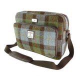 Plaid patterned bag with a strap on a white background