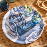Octopus-themed tray with two glasses of blue cocktails on a wooden surface